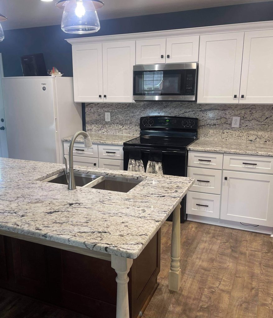 Technician restoring granite countertop in Charleston kitchen